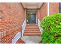 Inviting brick stairway leads to a welcoming front door with decorative plants and stylish details at 1868 Palmetto Isle Dr, Mount Pleasant, SC 29466