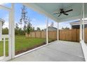 Covered patio featuring a ceiling fan and views of the fenced backyard and adjacent green space at 198 Winding Branch Dr, Summerville, SC 29486