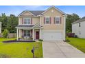 Inviting two-story house with a red front door, covered porch, and manicured front yard at 199 Meadow Wood Rd, Summerville, SC 29486