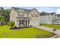 Charming two-story home with a well-manicured lawn and front porch seating area at 199 Meadow Wood Rd, Summerville, SC 29486