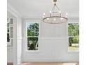 Elegant dining room with modern chandelier, hardwood floors, and ample natural light at 2004 Sea Water Dr, Charleston, SC 29412