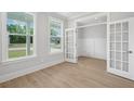 Bright office space featuring French doors, hardwood floors, and large windows at 2004 Sea Water Dr, Charleston, SC 29412