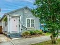 Charming single-story home featuring quaint porch, light-blue siding, and window box at 202 Fishburne St, Charleston, SC 29403