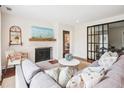 Bright and airy living room featuring hardwood floors, decorative fireplace, and comfortable seating at 22 Charlestowne Rd, Charleston, SC 29407
