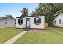 Charming home with a black and white exterior, black shutters, and window boxes at 2317 Kent Ave, North Charleston, SC 29405