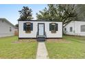 A charming home with a black and white exterior and flower boxes in front of the windows at 2317 Kent Ave, North Charleston, SC 29405