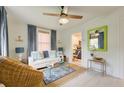 Bright living room features a modern ceiling fan, white couch, stylish rug, and a lime green mirror at 2317 Kent Ave, North Charleston, SC 29405