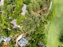 An aerial view displays the property boundaries with mature trees, a golf course, and a nearby residential area at 2653 Seabrook Island Rd, Seabrook Island, SC 29455
