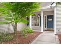 Inviting home entrance with a blue front door, well-manicured landscaping, and sidewalk at 2845 August Rd, Johns Island, SC 29455