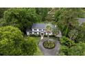 Aerial view of a beautiful two-story home with circular driveway surrounded by lush greenery and mature trees at 375 Seewee Cir, Mount Pleasant, SC 29464
