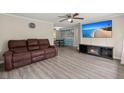 Bright living room with a comfortable brown leather couch, a large TV, and a view into the dining area at 407 Raysor St, Saint George, SC 29477