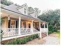 Inviting home with a classic front porch, dormer windows, and meticulous landscaping at 4150 Nature View Cir, Johns Island, SC 29455