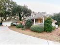 Beautiful house with a spacious driveway, attached garage, and lush green surroundings at 4150 Nature View Cir, Johns Island, SC 29455