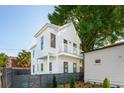 Two story home boasts white siding, a balcony, dark framed windows, and well-manicured landscaping at 42 Poinsett St # B, Charleston, SC 29403
