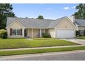 Lovely one-story home with a well-kept lawn, an attached garage, and neat landscaping for great curb appeal at 432 Equinox Cir, Ladson, SC 29456