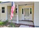 Close-up of the charming front porch featuring an American flag and the house number at 434 Antebellum Ln, Mount Pleasant, SC 29464
