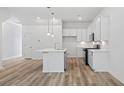 Open concept kitchen with white cabinets, stainless steel appliances, and a stylish kitchen island at 4436 Oakwood Ave, North Charleston, SC 29405