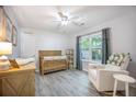 Cozy Bedroom with wood crib, white rocker chair, and lots of natural light at 512 Castle Hall Rd, Mount Pleasant, SC 29464