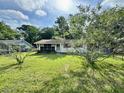 A single-story home with mature landscaping and a partially screened porch at 524 Kell Pl, Charleston, SC 29412