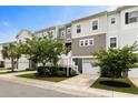 Charming townhome with attached garages, neutral siding, manicured lawn and beautiful, mature landscaping at 582 Mclernon Trce, Johns Island, SC 29455
