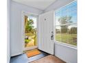 Inviting entryway featuring a white door, tile floors, and a window with blinds at 6231 Rolling Fork Rd # 1201-A, North Charleston, SC 29406