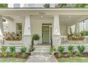 Inviting front porch with decorative plants, hanging flower baskets, and space for relaxing at 7053 Schooner St, Daniel Island, SC 29492