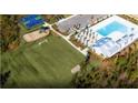 Aerial view featuring a community recreational area with a pool, playground, and sports courts at 730 Meadowbrook Lane, Summerville, SC 29486