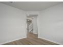 Spacious hallway with wood-look flooring, neutral walls, and views of the staircase, enhancing the home's flow at 758 Meadowbrook Lane, Summerville, SC 29486