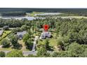 Aerial view of a lovely home surrounded by trees and near a lake at 7878 Gull Bay Dr, Awendaw, SC 29429