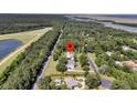 Aerial view of home with mature trees and near the coast at 7878 Gull Bay Dr, Awendaw, SC 29429