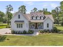 Beautiful two-story home with inviting front porch and manicured lawn at 7878 Gull Bay Dr, Awendaw, SC 29429