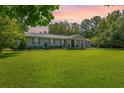 Charming home featuring a metal roof, classic shutters, and a well-manicured lawn perfect for outdoor enjoyment at 806 Appii Rd, Moncks Corner, SC 29461