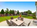Expansive backyard featuring a patio, lush lawn, mature trees, and play area at 9785 Black Willow Ln, Ladson, SC 29456