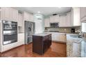 Well-lit kitchen with stainless steel appliances, granite counters, and an island at 9785 Black Willow Ln, Ladson, SC 29456