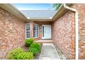 Inviting entryway with brick walls, a white front door, and manicured landscaping at 100 Cheshire Dr, Goose Creek, SC 29445