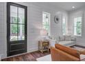 Comfortable living room boasts shiplap walls, stylish furniture, and natural light at 105 Bobcat Ln, Ravenel, SC 29470