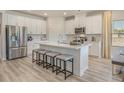 Spacious kitchen featuring an island with seating, stainless steel appliances, and white cabinets at 109 Indigo Cove Blvd, Summerville, SC 29486