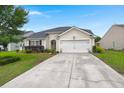 Charming single-story home featuring a well-manicured lawn, inviting curb appeal, and an attached two-car garage at 1103 Cates Ct, Summerville, SC 29483