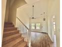 Spacious living room with high ceiling, staircase, and wood flooring at 112 Lake Jogassee Dr, Summerville, SC 29485