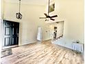 Bright living room boasts vaulted ceilings, wood floors, and stylish light fixtures at 112 Lake Jogassee Dr, Summerville, SC 29485