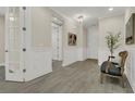 Welcoming foyer with wood-look tile floors, chair rail, and a view of the home's interior at 117 Harbor Trace Ln, Summerville, SC 29486