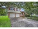 Two-story brick home boasts an attached two-car garage and red shutters at 117 Myer Ln, Goose Creek, SC 29445