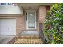 Home's brick front porch includes a storm door and metal handrail at 117 Myer Ln, Goose Creek, SC 29445