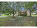 Charming single-Gathering home with mature trees, a well-maintained lawn, and traditional brick exterior at 117 Myer Ln, Goose Creek, SC 29445