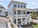 Inviting three-story home with a spacious balcony and a charming American flag at 1182 Welcome Dr Dr, Mount Pleasant, SC 29464