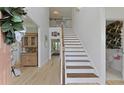 Grand two-story foyer with wooden staircase, hardwood floors, and natural light at 1216 Rivers Reach Dr, Charleston, SC 29492