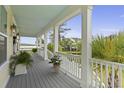 Large relaxing porch with light-blue painted ceilings overlooking lush landscaping and a beautiful backyard view at 1216 Rivers Reach Dr, Charleston, SC 29492