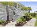 Staircase to a raised house with beautiful greenery and landscaping on either side at 1216 Rivers Reach Dr, Charleston, SC 29492
