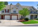 Inviting townhouse featuring a private garage, brick accents, and an adorable green front lawn at 125 Greyson Cir, Goose Creek, SC 29445
