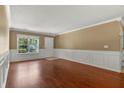 Inviting living area with gleaming hardwood floors, chair rail molding, and a bright window at 125 Greyson Cir, Goose Creek, SC 29445